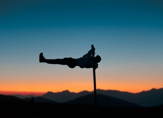 Closeup of a man on a street workout against the sunset sky