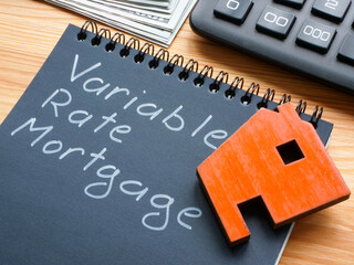 Note with inscription variable rate mortgage VRM and model of house.