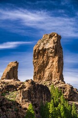 Vertical shot of the  Roque Nublo under a cloudy sky on a sunny day, Gran Canary, Spain