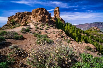 Roque Nublo under a cloudy sky on a sunny day, Gran Canary, Spain