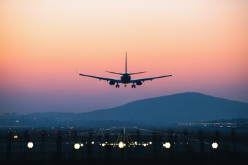 Airplane departing from airport during sunset