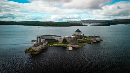 Aerial view of statue in background of Saint Patrick Purgatory church in Donegal