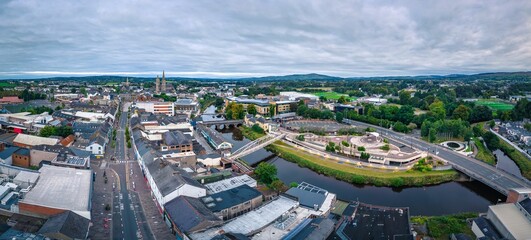 Aerial view of cityscape Omagh surrounded by dense trees