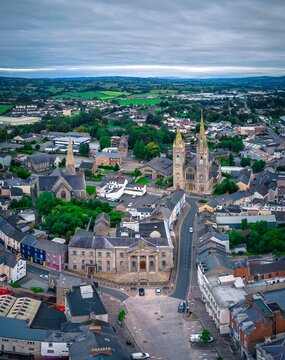 Aerial view of cityscape Omagh surrounded by dense trees