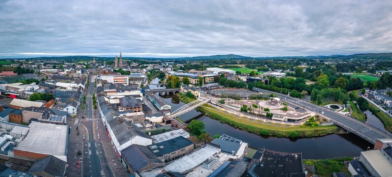 Aerial view of cityscape Omagh surrounded by dense trees