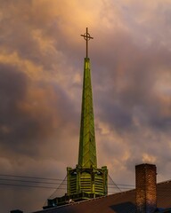 Tall tower with cross sign on a sunset afternoon