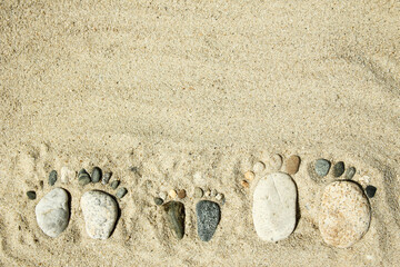 Feet of a family of stones on the sea