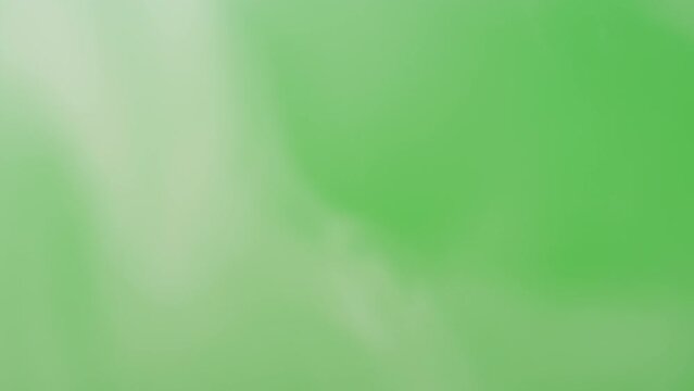 Abstract smoke on green chroma key background. Smoking cigarettes or marijuana weed, steam clouds close-up.