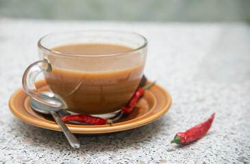 cup of coffee with red chili peppers