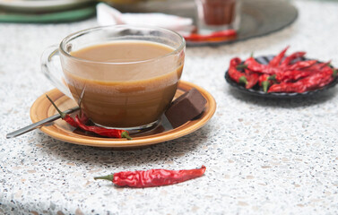 cup of hot coffee with red chili pepper