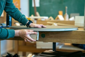 Man making a table in a woodworking factory