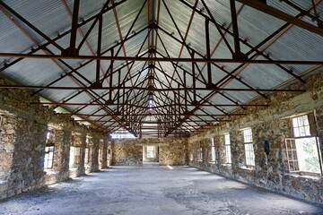 Empty warehouse with stone walls and steel ceiling