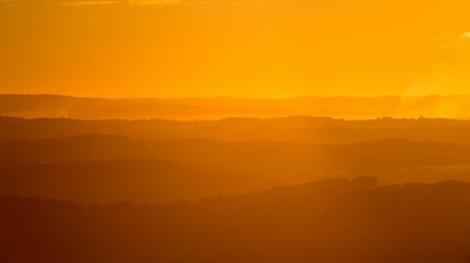 Bright orange sunset over the silhouette of the mountains