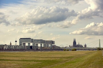 Fototapeta na wymiar Field, modern buildings and cathedral in Cologne, Germany