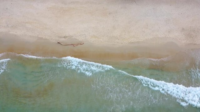 Aerial drone footage of the waves calmly washing the beach at Playa de Choroni, Venezuela
