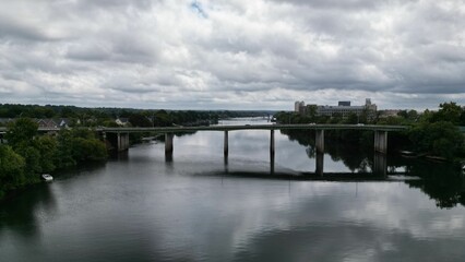 Drone view of a bridge connecting the riverbanks on a cloudy day