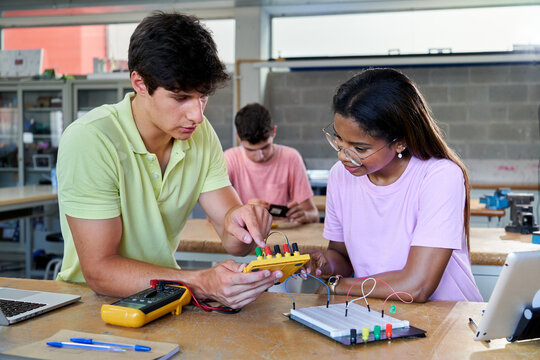 Multiracial Students In Electronic Class Learning Together And Helping Each Other. Teenagers Colleagues At School Room Studying Technology.