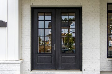 Modern black door of a house in a suburban area