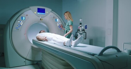 Patient is preparing for MRI examination. Man enters into MRI capsule. Female doctor calms patient and conducts magnetic resonance imaging. Medical worker is pressing buttons on MRI capsule. - Powered by Adobe