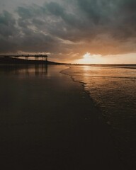 Fototapeta na wymiar Silhouette shot of the pier at Saltburn beach in Saltburn-by-the-Sea, North Yorkshire