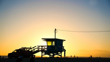 Silhouette of a lifeguard tower on the beach shore in Los Angeles