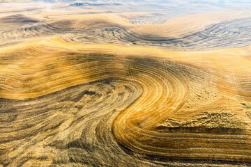 Beautiful view of a harvested wheat field with a rolling hill surface