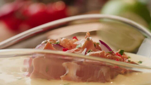 Chef cooking ceviche, leche de Tigre, traditional peruvian food, ceviche on table close-up. Traditional Peruvian or mexican cuisine with fresh seafood prawns in wine glass. 