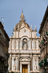 Fototapeta premium Columns and statues of the Baroque facade of the Cathedral Basilica of St. Agates in the city of Catania, on the island of Sicily