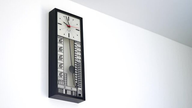 time is money concept. Pendulum clock on a white wall