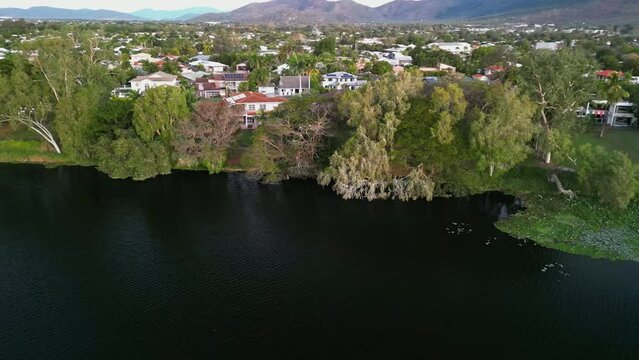 Drone shot of a river and the cityscape view of Townsville with Stuart Mountain