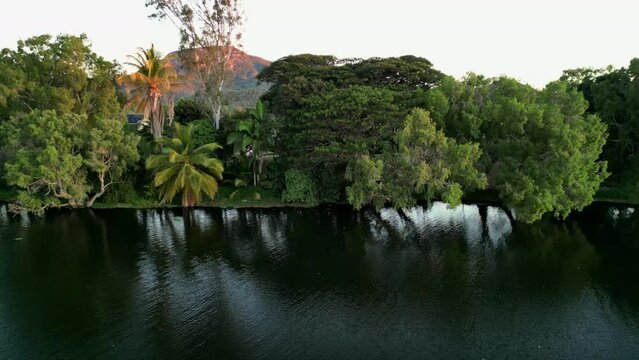 Drone shot of a river and the cityscape view of Townsville with Stuart Mountain