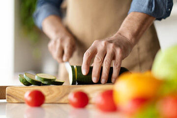Healthy Eating. Unrecognizable Man Cooking Vegetable Meal In Kitchen