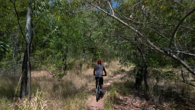 Person riding a bicycle through Pallarenda mountain trail in Townsville, Queensland, Australia