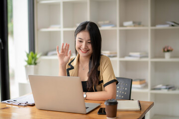 asian young woman has video chat with friends with webcam, Happy young asian business woman waving hands to greeting partner during making video conference with her team.