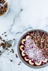 Vertical top view of the breakfast bowl with oats, cashew and grated coconut on top