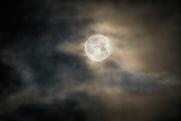 Naklejka na ściany i meble Beautiful full moon in a cloudy dark sky