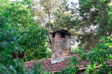 Brick chimney and red tiled roof.