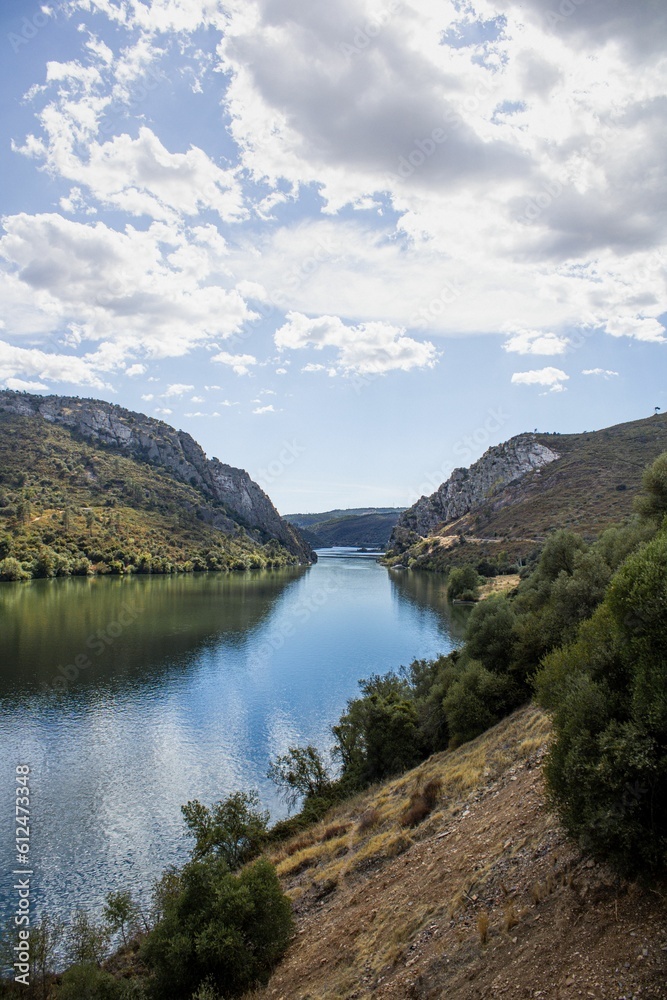 Wall mural Beautiful landscape of a river between green hills on a sunny day