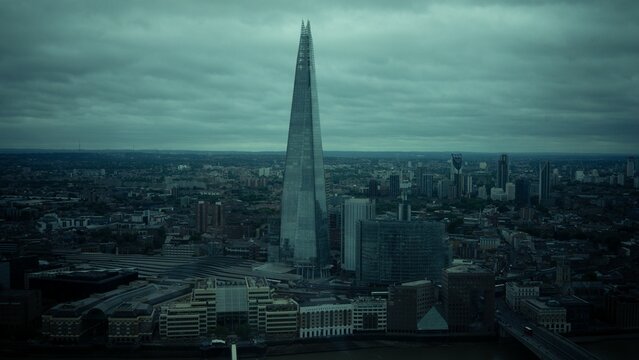 Tallest Shard skyscraper with London city in the background on a gloomy day