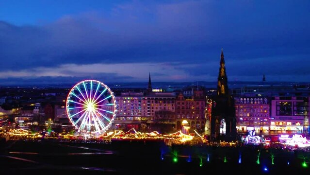Aerial view of Edinburgh Christmas market with fairy wheel and colorful lights at night
