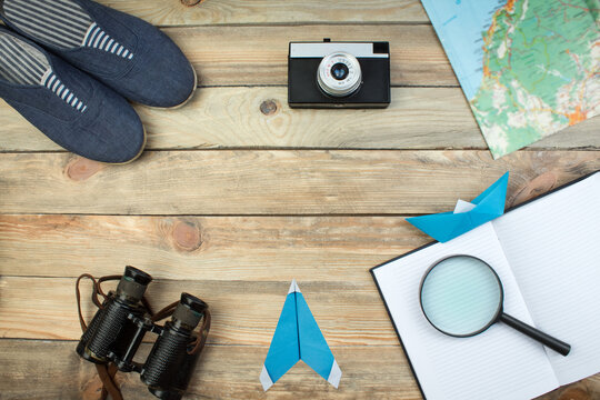 Accessories for travel top view on wooden background with copy space. Adventure and wanderlust concept image with travel accessories. Preparing for an exotic trip, journey and sightseeing.