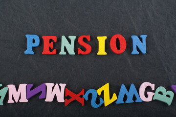 PENSION word on black board background composed from colorful abc alphabet block wooden letters,...