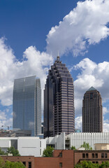Downtown Atlanta Skyline showing several prominent buildings and hotels under a blue sky.