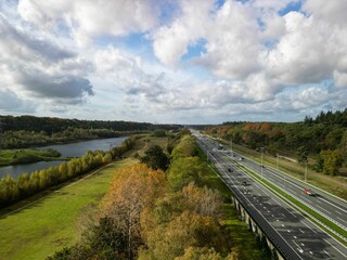 Aerial of a highway alongside a river in Utrechtse Heuvelrug the Netherlands during the daytime