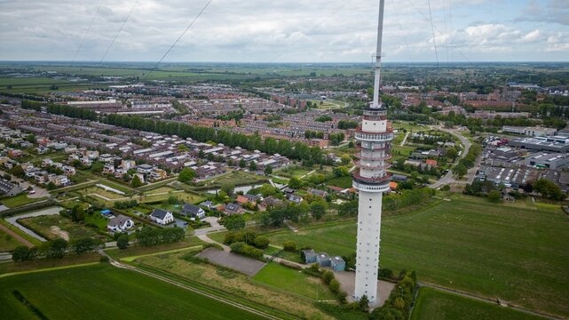 A Gerbrandy Tower next to a city and greenfield