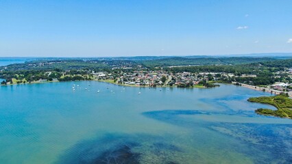 Fototapeta premium Landscape aerial view of Warners Bay lake with blue sky, Australia
