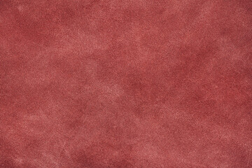 Texture of dark red suede, matte background. Fabric, leather, material, accessories manufacturing