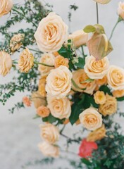Shallow focus shot of a beautiful bouquet with orange garden roses with blur background