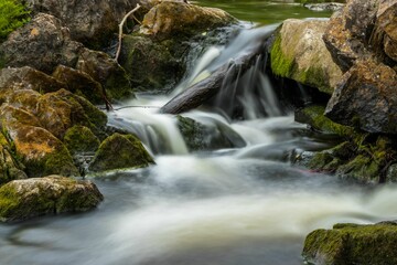 Naklejka na ściany i meble Beautiful shot of rocks in a mountain creek