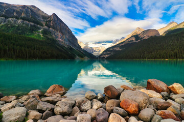 The Iconic, world famous, picture perfect Lake Louise is framed in the early morning sun near Banff in the Canada rockies